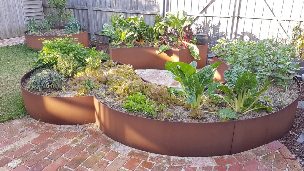 Custom curved raised steel vegetable garden bed