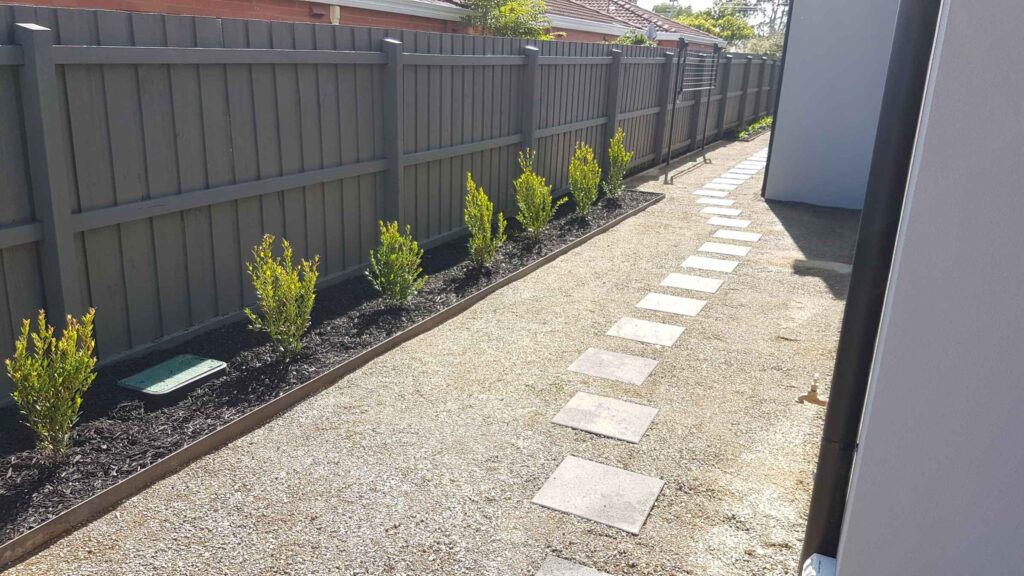Steel garden edging beside gravel and stepping stones